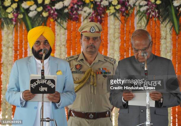 Aam Aadmi Party leader Bhagwant Mann takes the oath as Chief Minister of Punjab, administered by Punjab's governor Banwarilal Purohit during the...