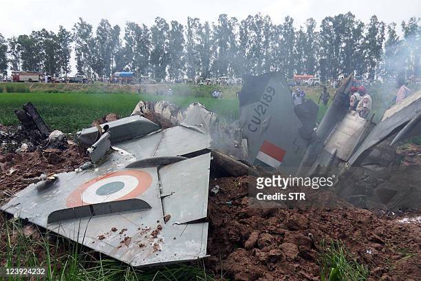 Indian Air Force personnel stand by the wreckage of a MiG-21 aircraft that crashed in a field in Rajgarh, in Patiala district on September 6, 2011....