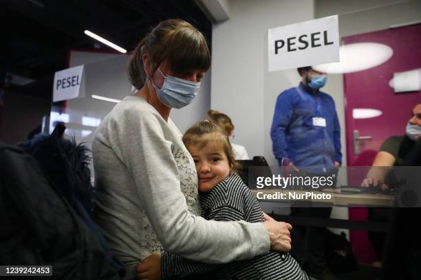 Refugees from Ukraine who fled to Poland after Russian attack are seen at the register point in Tauron Arena to obtain a PESEL national...