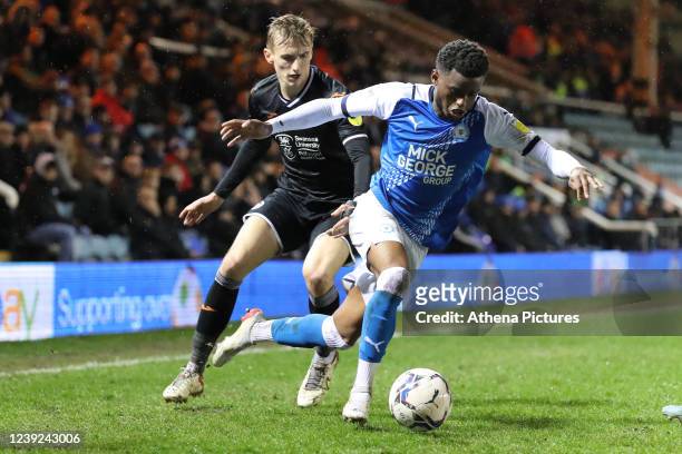 Flynn Downes of Swansea City challenges Bali Mumba of Peterborough during the Sky Bet Championship match between Peterborough United and Swansea City...