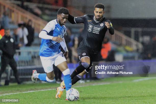 Bali Mumba of Peterborough is challenged by Cyrus Christie of Swansea City during the Sky Bet Championship match between Peterborough United and...