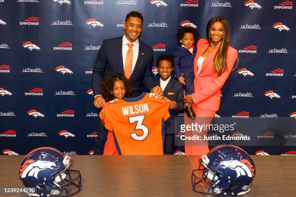 Quarterback Russell Wilson of the Denver Broncos poses with his family , Sienna, Future, Win and Ciara following an introductory press conference at...