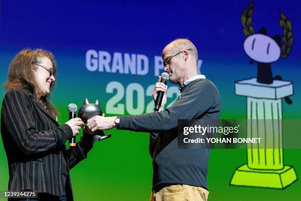 Chris Ware gives the "Grand Prix" to Canada's Julie Doucet for her all work during the 49th Angouleme International Comics Festival , in Angouleme,...