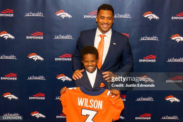 Quarterback Russell Wilson of the Denver Broncos poses with his son Future Zahir Wilburn following an introductory press conference at UCHealth...