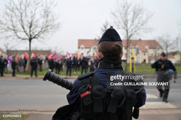 Police officers stand in front of protestors before a meeting for France's far-right party "Reconquete!" leader, media pundit and candidate for the...