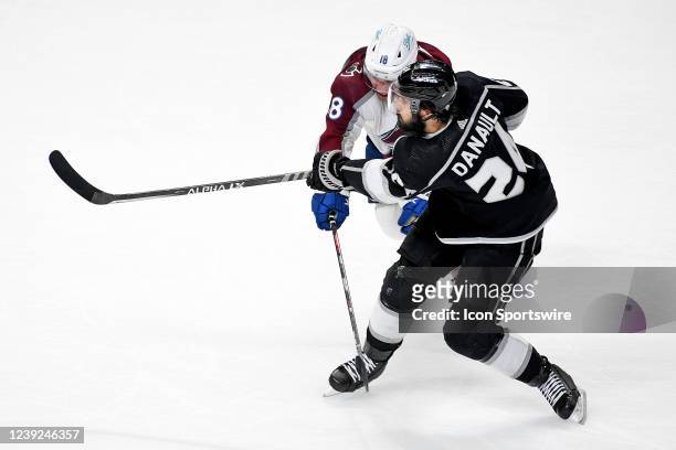 Los Angeles Kings Center Phillip Danault takes a shot on goal as Colorado Avalanche Winger Alex Newhook defends during a Los Angeles Kings game...
