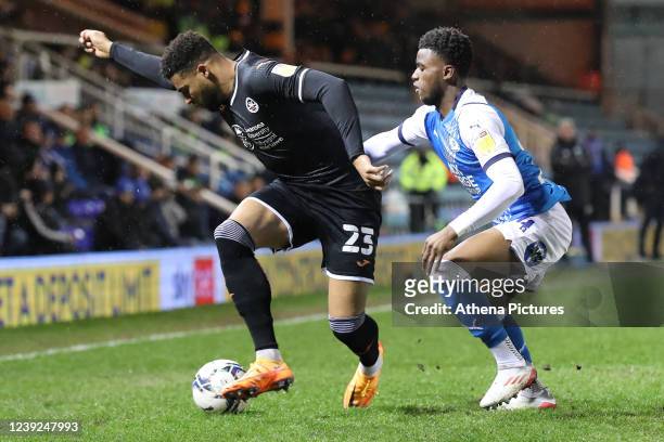 Cyrus Christie of Swansea City is challenged by Bali Mumba of Peterborough during the Sky Bet Championship match between Peterborough United and...