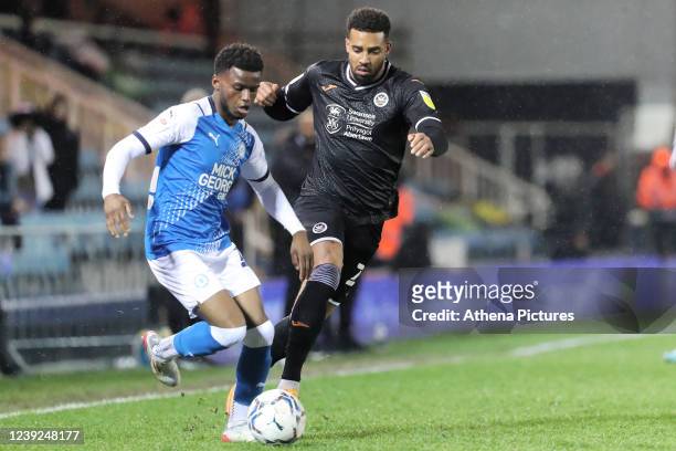 Bali Mumba of Peterborough challenged by Cyrus Christie of Swansea City during the Sky Bet Championship match between Peterborough United and Swansea...
