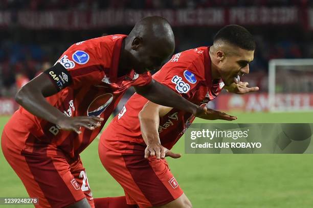 America de Cali's Carlos Sierra celebrates with Adrian Ramos after scoring against Independiente Medellin during the Sudamericana Cup first round...