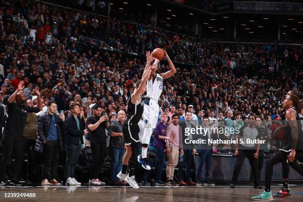 Spencer Dinwiddie of the Dallas Mavericks shoots a three point basket to win the game against the Brooklyn Nets on March 16, 2022 at Barclays Center...