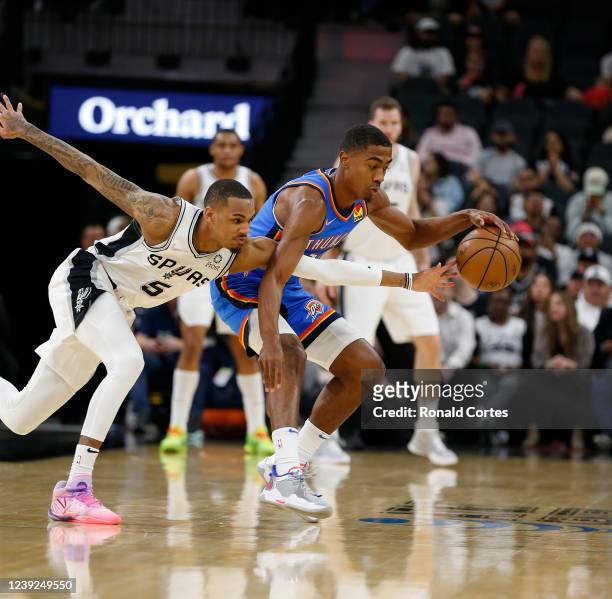 Dejounte Murray of the San Antonio Spurs attempts a steal the ball from Theo Maledon of the Oklahoma City Thunder in the first half at AT&T Center on...