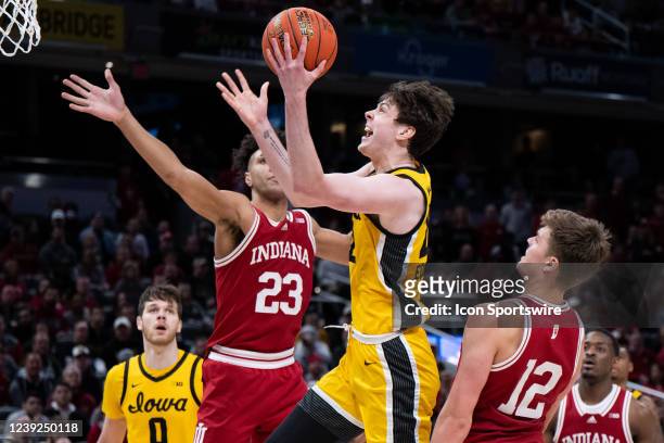 Iowa Hawkeyes forward Patrick McCaffery drives past Indiana Hoosiers forward Miller Kopp for a score during the mens Big Ten tournament college...