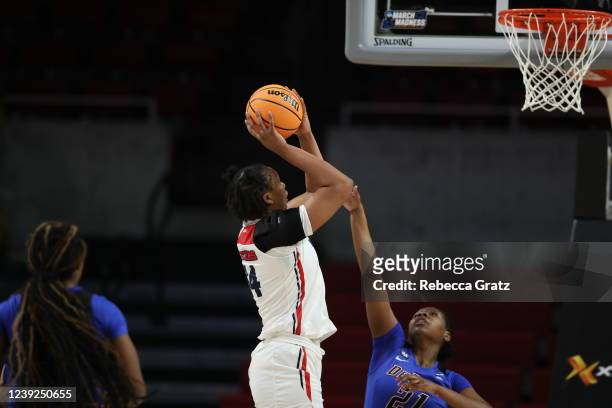 Tenin Magassa of the the Dayton Flyers shoots over Darrione Rogers of the DePaul Blue Demons during the First Four round of the 2022 NCAA Women's...