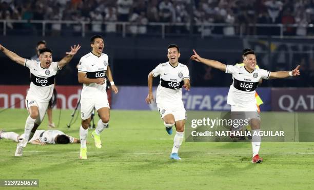 Paraguay's Olimpia players celebrate their victory after the penalty shoot-out at the end of the Copa Libertadores third round second leg football...