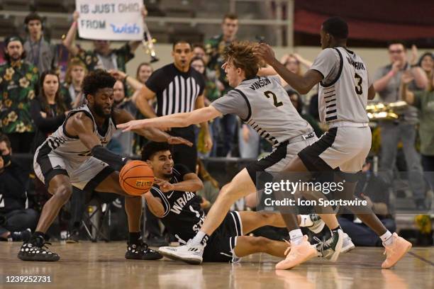 Wright State guard Trey Calvin passes between Northern Kentucky guard Sam Vinson , Northern Kentucky guard Marques Warrick , and Northern Kentucky...