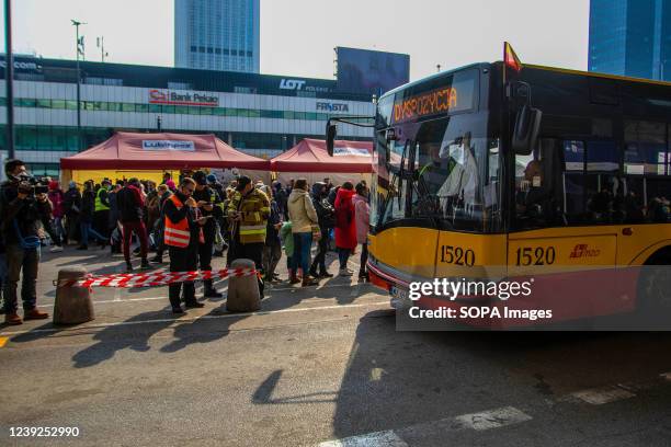 Bus in front of Warsaw Central train station waits for the Ukrainian refugees to onboard. Many of the Ukrainians who have fled to Poland arrive at...