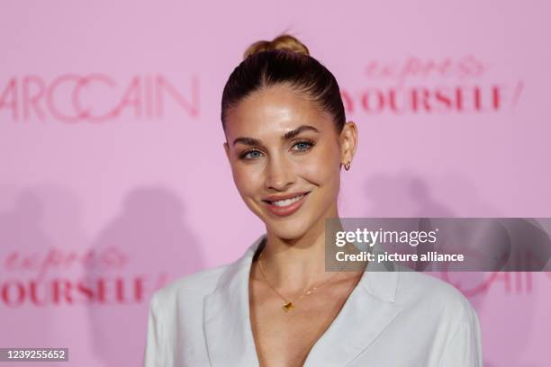 March 2022, Berlin: Berlin Fashion Week: Ann-Kathrin Götze arrives at the Wintergarten Varieté for the show of the label Marc Cain and stands on the...