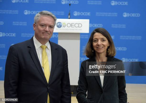 Secretary General Mathias Cormann and OECD Chief Economist Laurence Boone pose before giving a press conference about the impacts and policy...