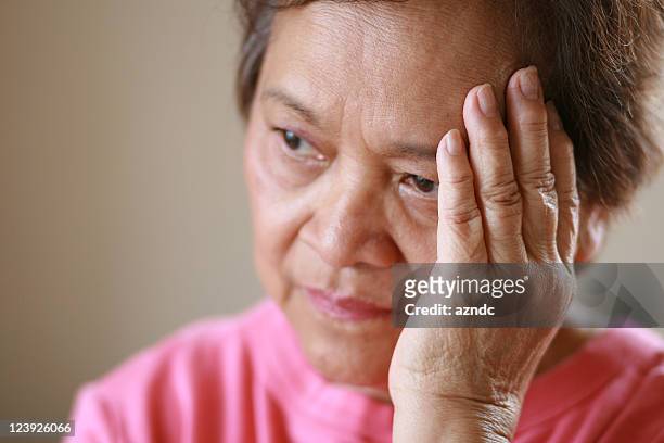 older woman worried about the future - asian violence stock pictures, royalty-free photos & images