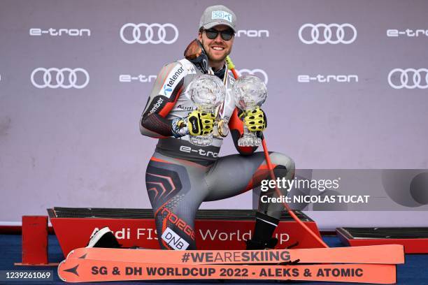 Norway's Aleksander Aamodt Kilde celebrates on the podium with the small globe of the Men's Super-G and the small globe of the Men's downhill of the...