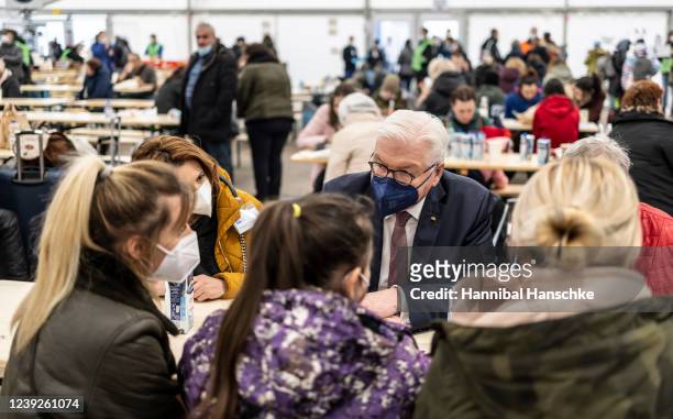German President Frank-Walter Steinmeier talks with refugees from Odessa of Ukraine as he visits a reception tent for the refugees in front of the...