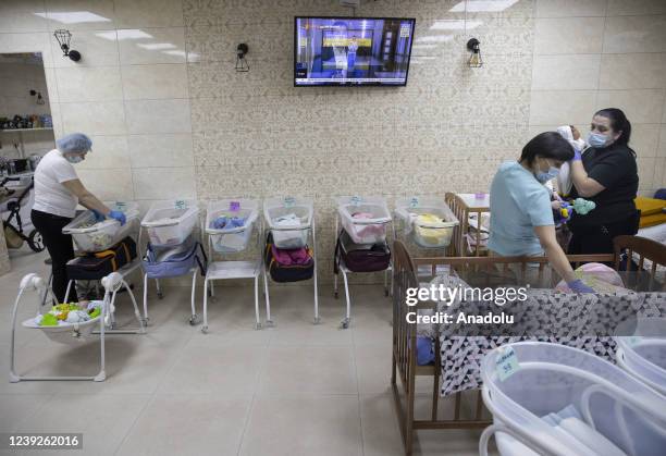 Newborn babies are seen inside their cribs in Kyiv, Ukraine on March 17, 2022. Surrogate-born babies cannot reunite with their biological families...