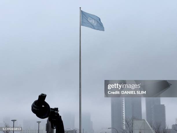 The Knotted Gun, sculpture by Swedish artist Carl Fredrik Reuterswärd is seen with the United Nations flag at the UN headquarters in New York on...