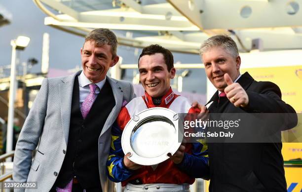 Gloucestershire , United Kingdom - 17 March 2022; Jockey Jonathan Burke with owners David Crosse, left, and Noel Fehily, right, after winning the...