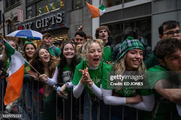 Spectators watch a St. Patrick's day parade in New York on March 17, 2022.