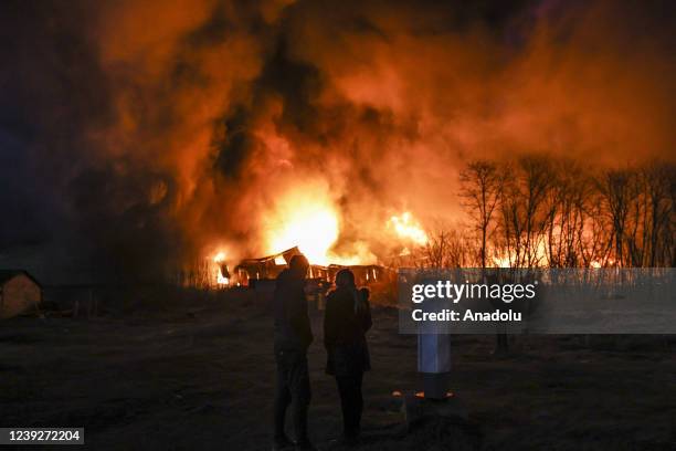 Smoke and flames rise due to fire broke out after Russian rockets hit warehouses in Sviatoshynskyi district, Kyiv, Ukraine on March 17, 2022. At...