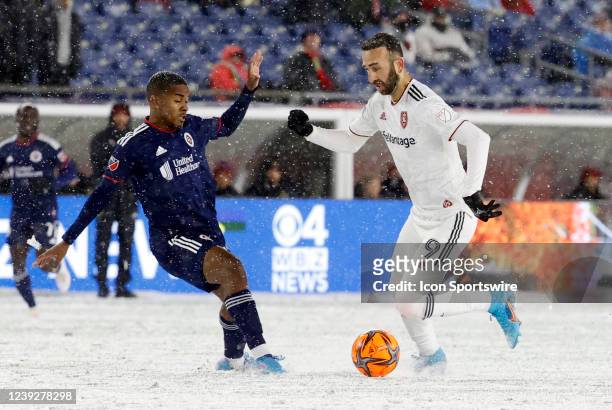 New England Revolution midfielder Lucas Maciel Felix moves in on Real Salt Lake midfielder Justin Meram during a match between the New England...