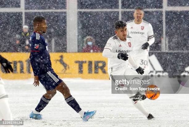 Real Salt Lake midfielder Pablo Ruiz plays a ball past New England Revolution midfielder Lucas Maciel Felix during a match between the New England...