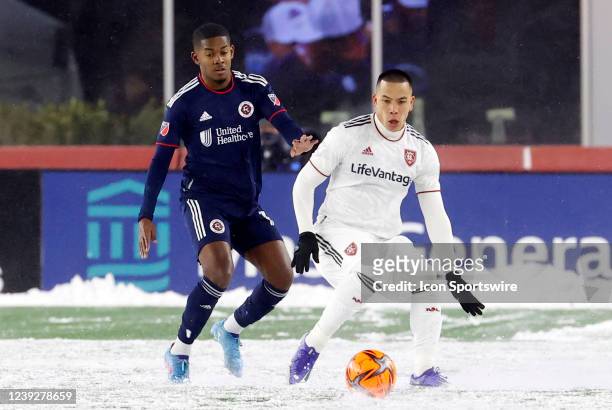 Real Salt Lake forward Bobby Wood watched by New England Revolution midfielder Lucas Maciel Felix during a match between the New England Revolution...