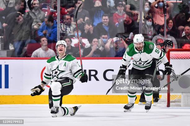 John Klingberg of the Dallas Stars celebrates his overtime goal as teammate Tyler Seguin reacts against the Montreal Canadiens at Centre Bell on...