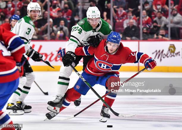 Denis Gurianov of the Dallas Stars challenges Chris Wideman of the Montreal Canadiens during the third period at Centre Bell on March 17, 2022 in...