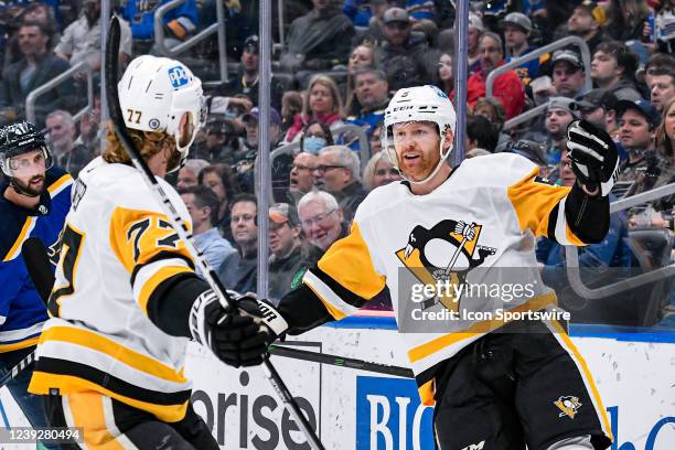 Pittsburgh Penguins defenseman Mike Matheson goes to celebrate his goal with teammate center Jeff Carter during a game between the Pittsburgh...