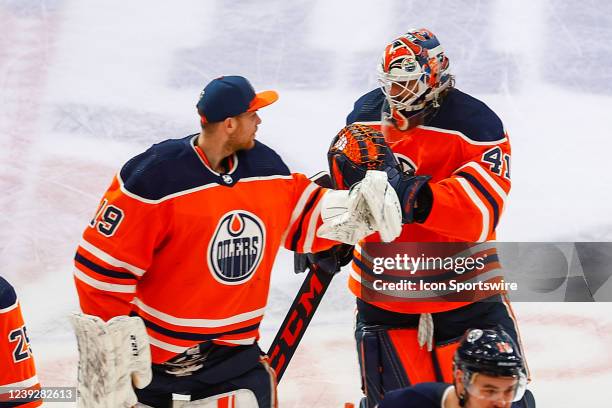 Edmonton Oilers Goalie Mike Smith is congratulated by Edmonton Oilers Goalie Mikko Koskinen in the third period during the Edmonton Oilers game...