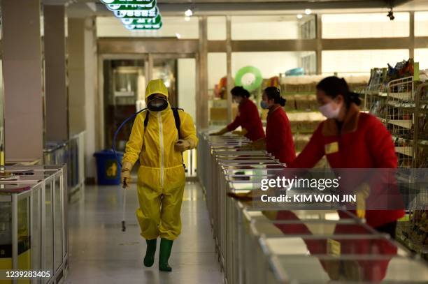 Employees spray disinfectant and wipe surfaces as part of preventative measures against the Covid-19 coronavirus at the Pyongyang Children's...