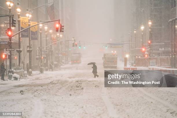 Person walks in the snow during a Nor'easter storm in Manhattan on January 29, 2022.
