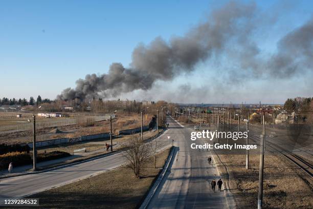 Smoke is seen above buildings close to the airport on March 18, 2022 in Lviv, Ukraine. Lviv's mayor said on Telegram that the airport was not hit,...