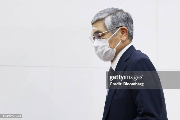 Haruhiko Kuroda, governor of the Bank of Japan , wearing a protective face mask, arrives for a news conference at the central bank's headquarters in...