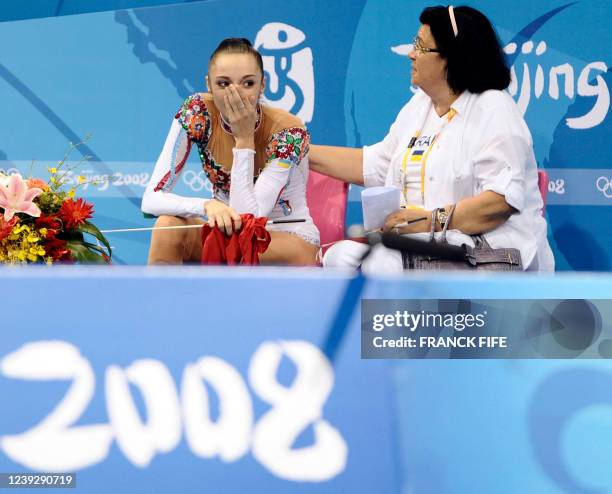 Ukraine's Ganna Bessonova sits by her coach Irina Deriugina after competing in the individual all-around final of the rhythmic gymnastics at the...