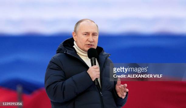 Russian President Vladimir Putin gives a speech at a concert marking the eighth anniversary of Russia's annexation of Crimea at the Luzhniki stadium...