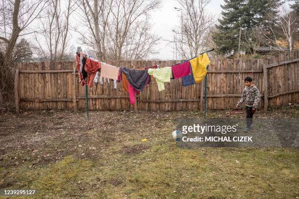 Aron, an Ukrainian refugee and Roma, plays football in the camp in Revnice village, on March 18 35 km near Prague. - A campsite turned refugee...