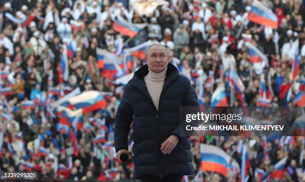 Russian President Vladimir Putin attends a concert marking the eighth anniversary of Russia's annexation of Crimea at the Luzhniki stadium in Moscow...