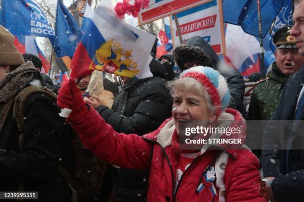 People take part in celebrations marking the eighth anniversary of Russia's annexation of Crimea in Simferopol on March 18, 2022.