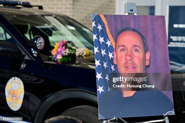 The Boulder police department put an empty patrol car and a photo of slain Officer Eric Talley up in front of the building ahead of the one-year...