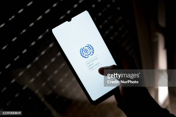 In this photo illustration an International Labour Organization logo seen displayed on a smartphone screen in Athens, Greece on March 18, 2022.