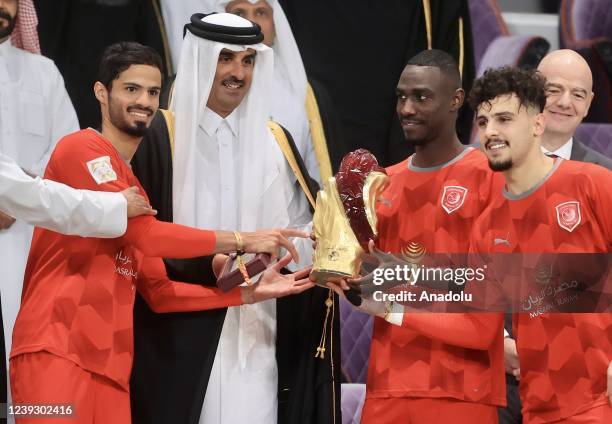 Players of Al-Duhail receive the trophy from Emir of Qatar, Tamim bin Hamad Al Thani after winning the Qatar Amir Cup Final against Al-Gharafa at the...