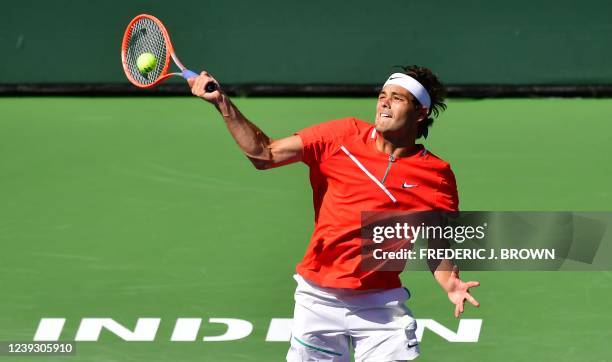 Taylor Fritz of the US hits a forehand return to Miomir Kecmanovic of Serbia during their ATP quarterfinal match at the Indian Wells tennis...